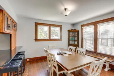 a dining room with a wooden table and chairs at Walk to Lake Erie Spacious Home in Sandusky! in Sandusky