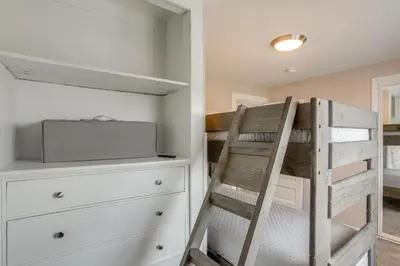 a bedroom with a bunk bed and a dresser at Walk to Lake Erie Spacious Home in Sandusky! in Sandusky