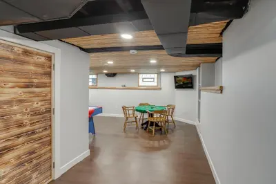 a dining room with a table and a barn door at Walk to Lake Erie Spacious Home in Sandusky! in Sandusky