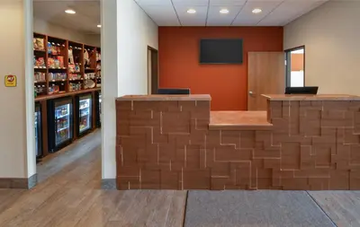 a lobby with a wall made out of brick at My Place Hotel-Pittsburgh North/Monaca, PA in Monaca