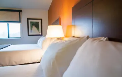 a bedroom with two beds and a lamp on the wall at My Place Hotel-Pittsburgh North/Monaca, PA in Monaca
