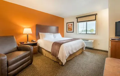 a hotel room with a bed and a chair at My Place Hotel-Pittsburgh North/Monaca, PA in Monaca