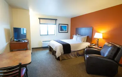 a hotel room with a bed and a chair and a table at My Place Hotel-Pittsburgh North/Monaca, PA in Monaca