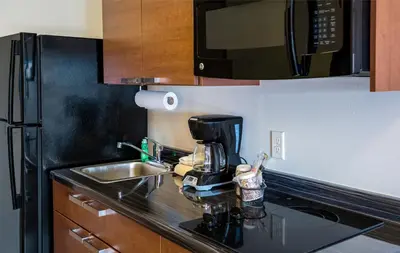 a kitchen with a sink and a coffee maker on a counter at My Place Hotel-Pittsburgh North/Monaca, PA in Monaca