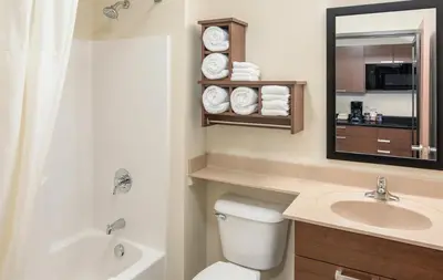 a bathroom with a toilet and a sink and a mirror at My Place Hotel-Pittsburgh North/Monaca, PA in Monaca