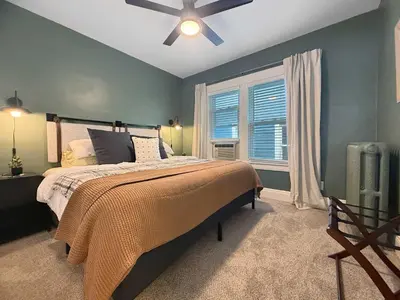 a bedroom with a bed and a ceiling fan at Chic Lakeside Retreat Steps from the Beach in Cleveland