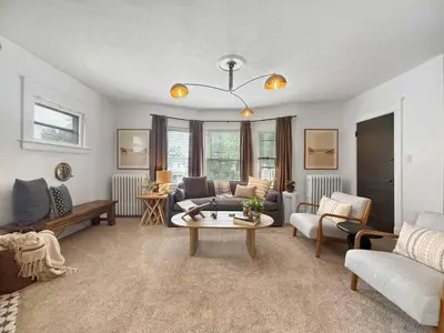 a living room with a couch and a table at Chic Lakeside Retreat Steps from the Beach in Cleveland