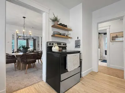 a kitchen with a stove and a dining room at Chic Lakeside Retreat Steps from the Beach in Cleveland