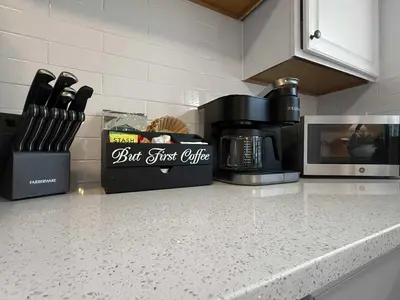 a kitchen counter with a coffeemaker and a coffee pot at Chic Lakeside Retreat Steps from the Beach in Cleveland