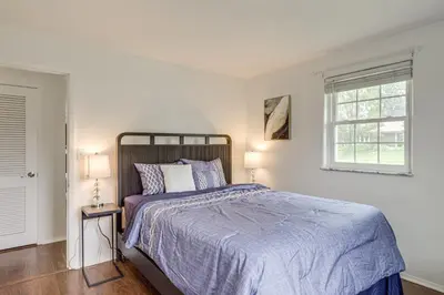 a white bedroom with a bed and a window at Dayton Family Home with Game Room Walk to City Park in Dayton