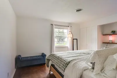a bedroom with a bed and a window at Dayton Family Home with Game Room Walk to City Park in Dayton