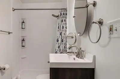 a bathroom with a sink and a mirror and a toilet at Dayton Family Home with Game Room Walk to City Park in Dayton