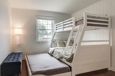 a bedroom with two bunk beds and a window at Dayton Family Home with Game Room Walk to City Park in Dayton