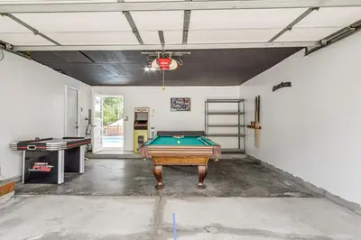 a garage with a ping pong table in it at Dayton Family Home with Game Room Walk to City Park in Dayton