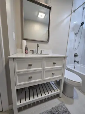 a bathroom with a sink and a toilet and a mirror at MidCity Country Charm in Cincinnati