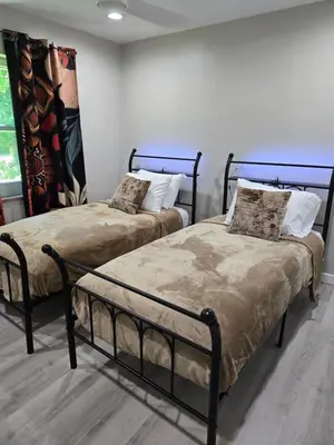 two beds sitting next to each other in a room at MidCity Country Charm in Cincinnati