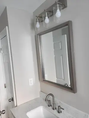 a bathroom with a sink and a mirror at MidCity Country Charm in Cincinnati