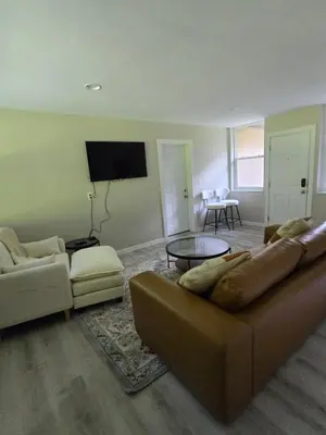 a living room with a couch and a table at MidCity Country Charm in Cincinnati