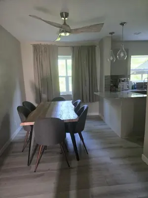 a dining room table and chairs in a kitchen at MidCity Country Charm in Cincinnati