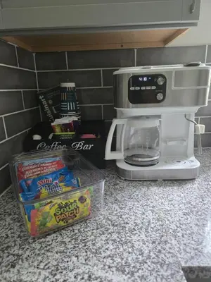 a counter top with a coffee maker and a box of chips at MidCity Country Charm in Cincinnati