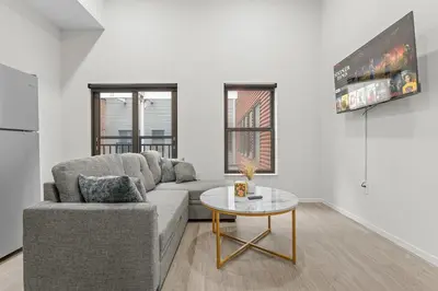 a living room with a couch and a table at Luxury Condo l DT l Playhouse Square l Sofa Bed in Cleveland