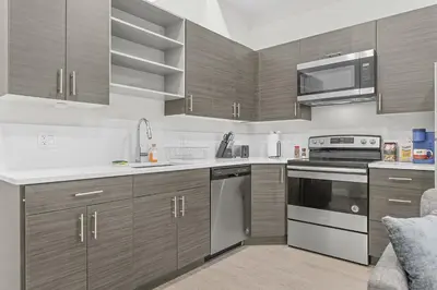 a kitchen with stainless steel appliances and wooden cabinets at Luxury Condo l DT l Playhouse Square l Sofa Bed in Cleveland