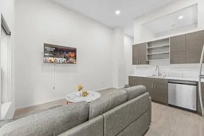 a living room with a couch and a kitchen at Luxury Condo l DT l Playhouse Square l Sofa Bed in Cleveland
