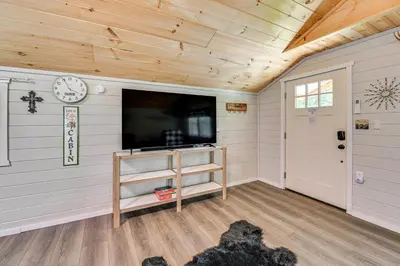 a room with a flat screen tv on a wall at 14 Mi to Kentucky Horse Park Creekside Cabin in Georgetown