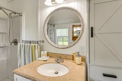 a bathroom with a sink and a mirror at 14 Mi to Kentucky Horse Park Creekside Cabin in Georgetown