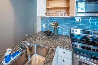 a kitchen with a sink and a stove at OTR 2 Lux Queen Beds Sleeps 5ppl Light Rail Wifi in Cincinnati