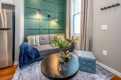a living room with a couch and a table at OTR 2 Lux Queen Beds Sleeps 5ppl Light Rail Wifi in Cincinnati