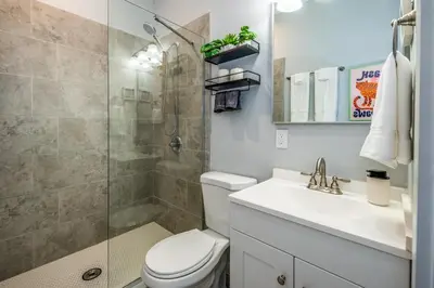 a bathroom with a shower and a toilet and a sink at OTR 2 Lux Queen Beds Sleeps 5ppl Light Rail Wifi in Cincinnati