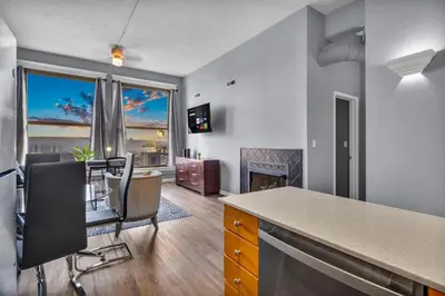 a kitchen and living room with a table and chairs at 1BR Loft Sauna & Walk to Theater & Campus in Cleveland