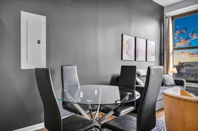 a dining room with a glass table and chairs at 1BR Loft Sauna & Walk to Theater & Campus in Cleveland