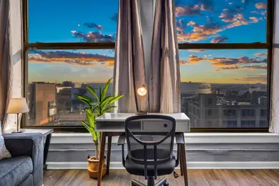 a desk in front of a window with a view at 1BR Loft Sauna & Walk to Theater & Campus in Cleveland