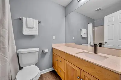 a bathroom with a toilet and a sink and a mirror at 1BR Loft Sauna & Walk to Theater & Campus in Cleveland