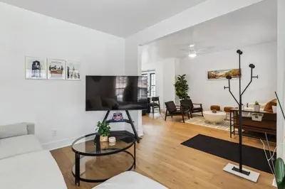 a living room with a couch and a table at Luxury Olivewood Oasis - 13 mins to Cleveland in Lakewood