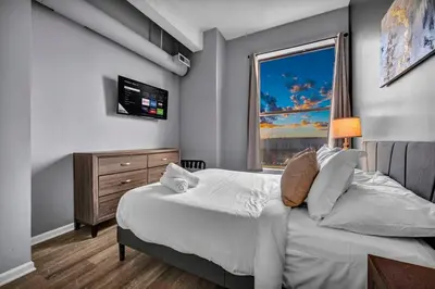 a bedroom with a large bed and a window at Downtown Cleveland Loft Near CSU, Playhouse, Arena in Cleveland