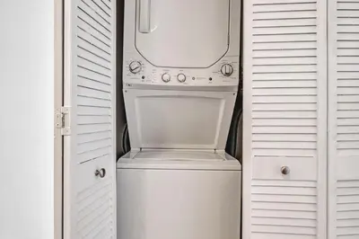 a white washer and dryer sitting in a closet at Downtown Cleveland Loft Near CSU, Playhouse, Arena in Cleveland