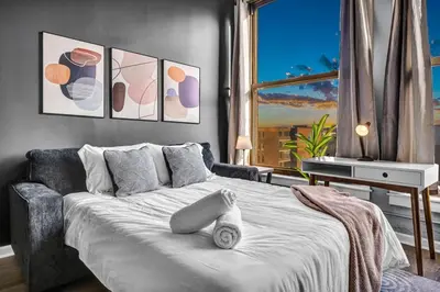 a bedroom with a large bed and a window at Downtown Cleveland Loft Near CSU, Playhouse, Arena in Cleveland