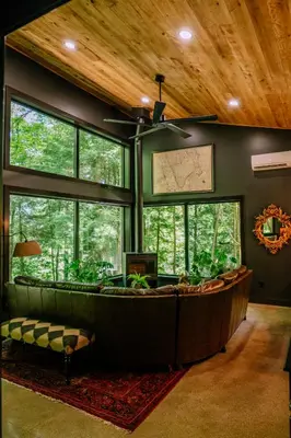a large living room with a large tub in a room with windows at Whiskey Lounge in Loudonville