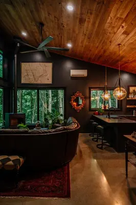a living room with a large couch and a table at Whiskey Lounge in Loudonville