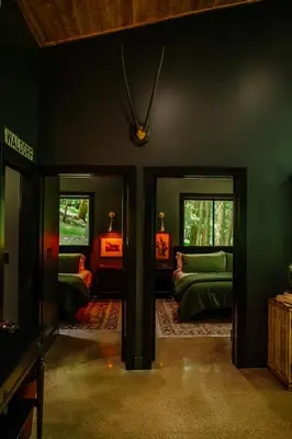 a dark room with two beds and two windows at Whiskey Lounge in Loudonville