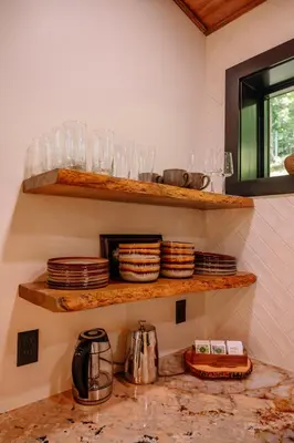 a kitchen with plates and glasses on shelves at Native Legacy in Loudonville