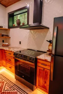 a kitchen with a stove and a refrigerator at Native Legacy in Loudonville
