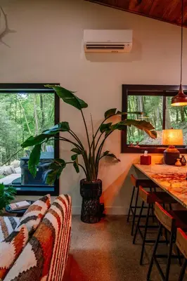 a living room with a plant in a vase at Native Legacy in Loudonville