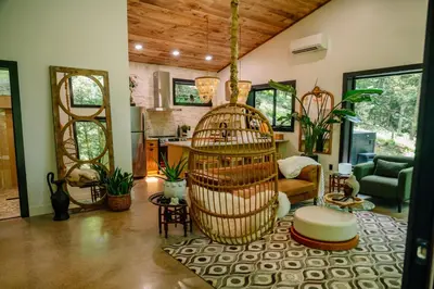 a living room with a bird cage in the middle at Lotus in Loudonville