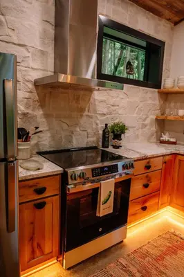 a kitchen with a stove and a refrigerator at Lotus in Loudonville