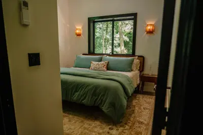 a bedroom with a green bed with a window at Lotus in Loudonville