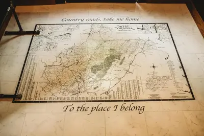 a map on a floor with the words to the place i belong at Corton Lodge on the Elk River - Riverview Suite